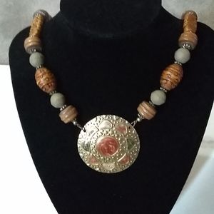 LR metal medallion, wooden bead necklace.